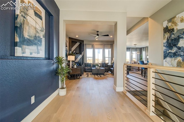 corridor featuring hardwood / wood-style floors and a notable chandelier