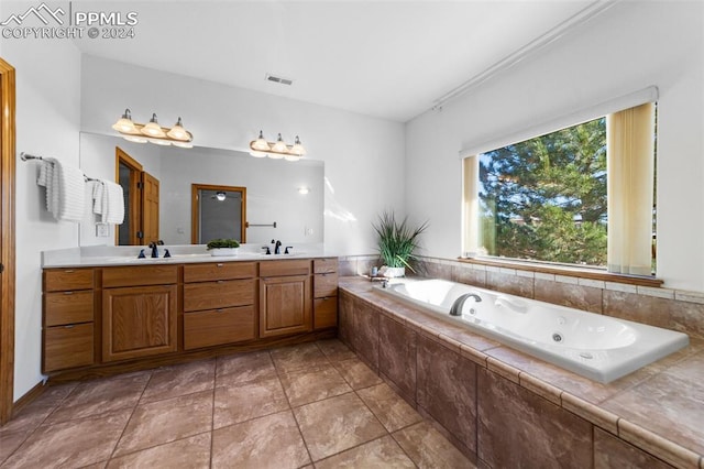 bathroom with vanity, tiled bath, and tile patterned floors