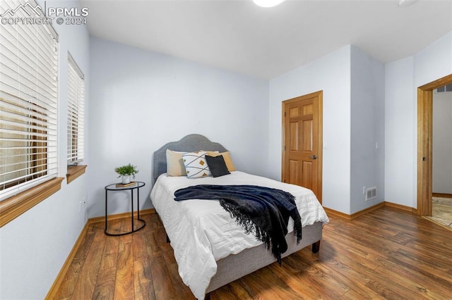 bedroom featuring dark hardwood / wood-style flooring