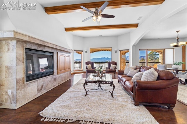 living room with a fireplace, beam ceiling, dark hardwood / wood-style flooring, and ceiling fan with notable chandelier