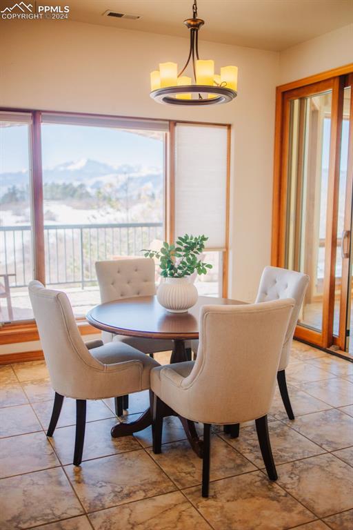 dining space featuring a notable chandelier and a wealth of natural light