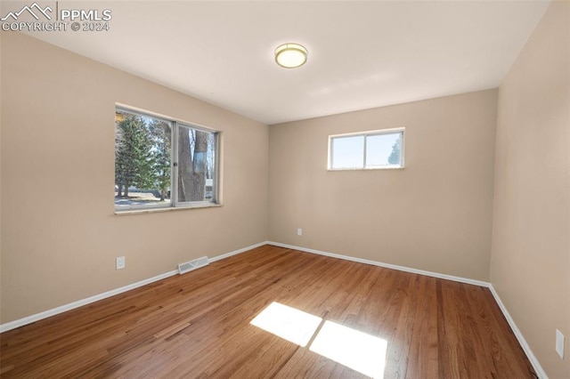 unfurnished room featuring hardwood / wood-style floors