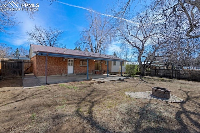 back of house with a patio and a fire pit