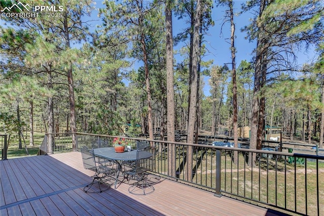 wooden terrace with outdoor dining area