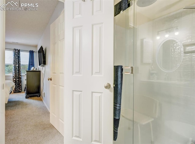 bathroom featuring lofted ceiling and a shower with shower door