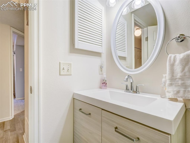 bathroom featuring vanity and wood-type flooring