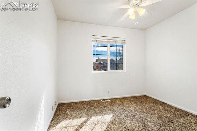 spare room featuring carpet flooring and ceiling fan