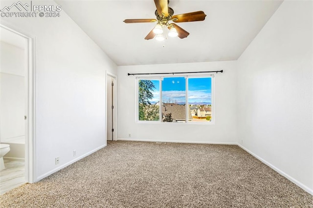 carpeted empty room with ceiling fan and lofted ceiling