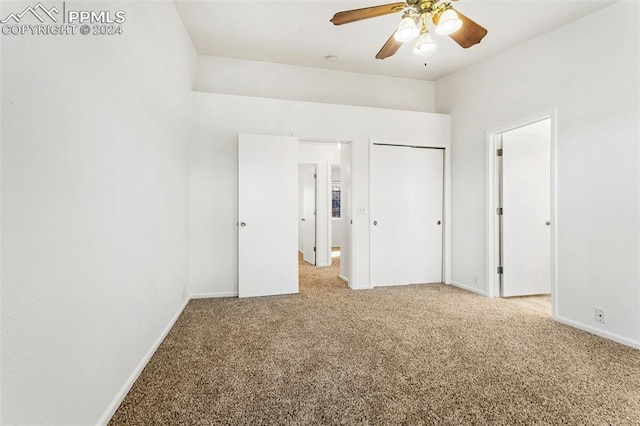 unfurnished bedroom featuring ceiling fan and light colored carpet