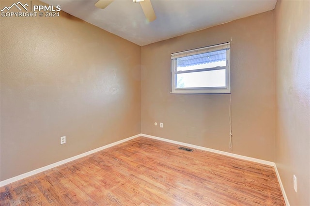 empty room featuring hardwood / wood-style floors and ceiling fan