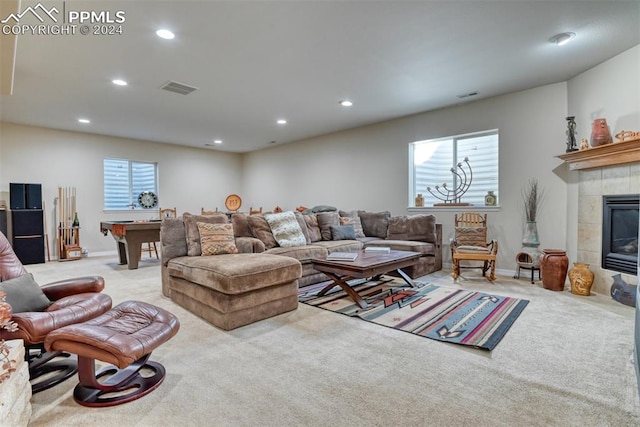 carpeted living room with a tile fireplace, a wealth of natural light, and billiards