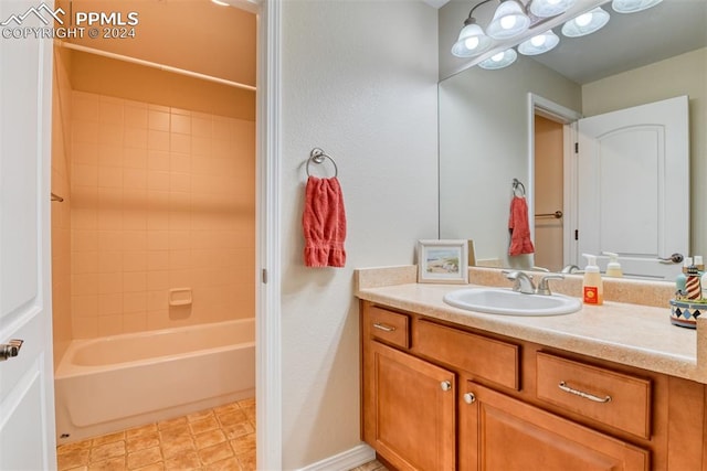 bathroom with vanity and tiled shower / bath