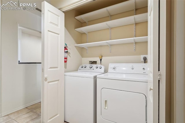 175 W Cheyenne Rd Unit 214, Colorado Springs, CO 80906 - laundry area with independent washer and dryer and light tile patterned floors