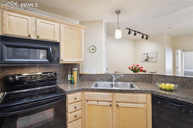 kitchen featuring black appliances, light brown cabinets, kitchen peninsula, and sink