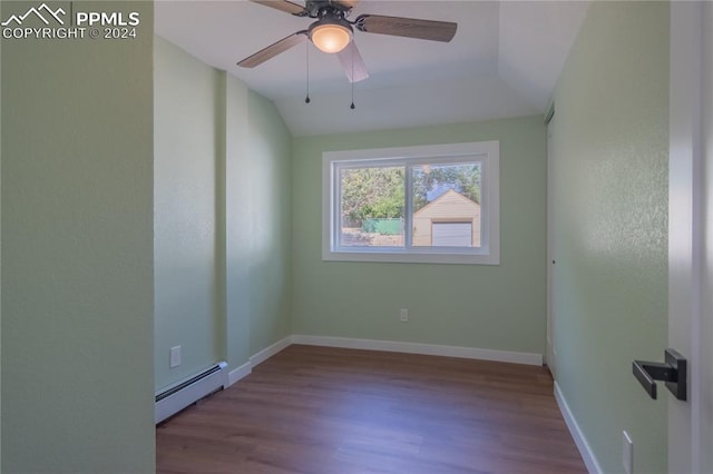 spare room with light hardwood / wood-style flooring, vaulted ceiling, ceiling fan, and a baseboard radiator