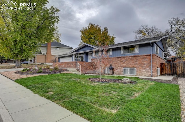 view of front of house featuring a garage and a front lawn