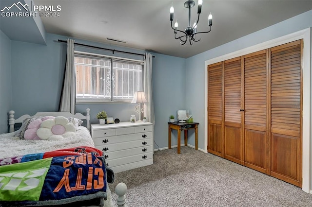 carpeted bedroom featuring an inviting chandelier