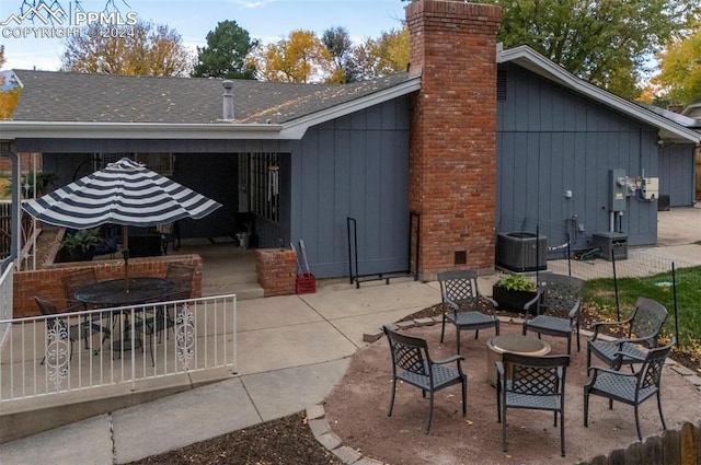 back of property with an outdoor fire pit and a patio area