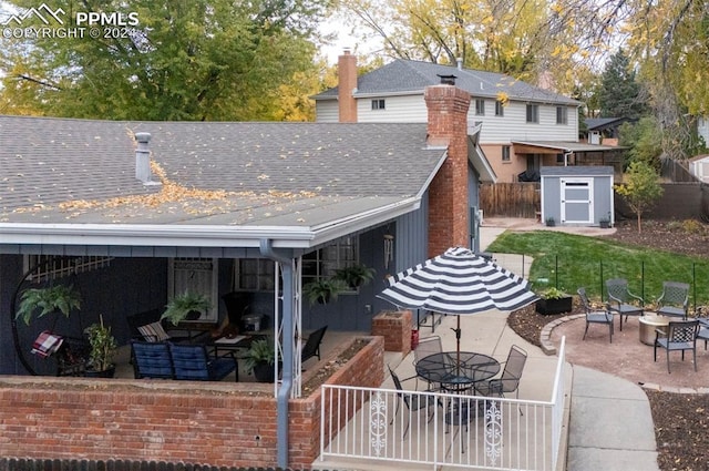 back of property featuring a storage shed and a patio area