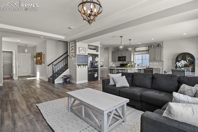 living room featuring dark hardwood / wood-style flooring and a notable chandelier