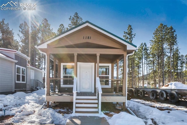 1181 Calm Mountain Pt, Woodland Park, CO 80863 - view of front facade featuring covered porch