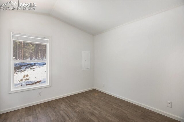 unfurnished room featuring vaulted ceiling and dark hardwood / wood-style floors