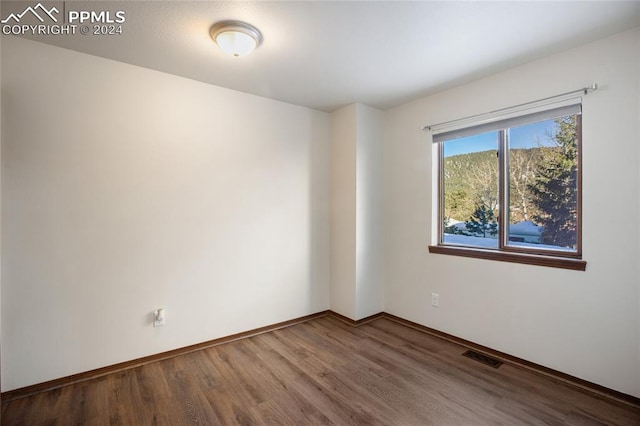 unfurnished room featuring hardwood / wood-style flooring