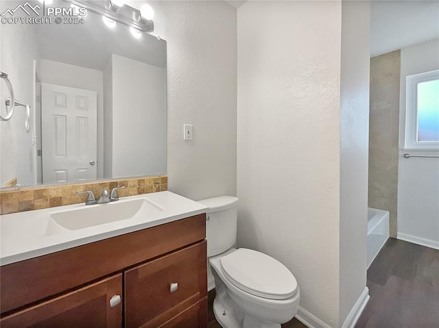 bathroom featuring wood-type flooring, vanity, and toilet