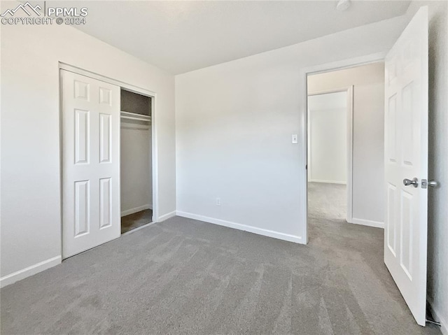 unfurnished bedroom featuring a closet and carpet floors