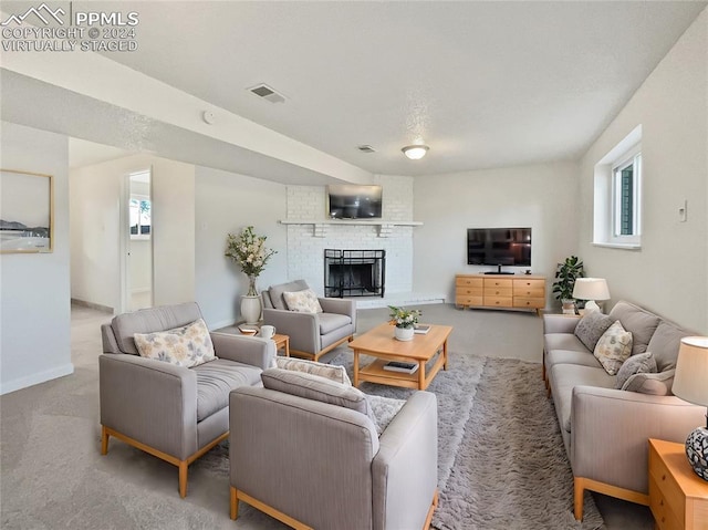 carpeted living room featuring a fireplace