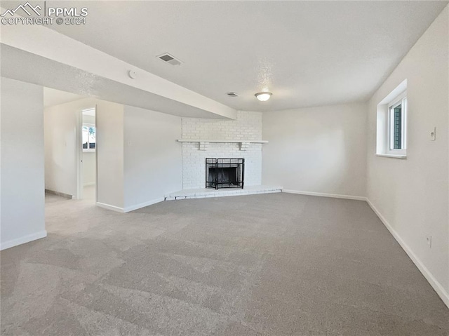 unfurnished living room featuring carpet flooring, a healthy amount of sunlight, and a fireplace