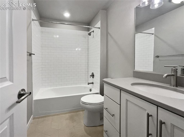 full bathroom with toilet, tiled shower / bath combo, and vanity