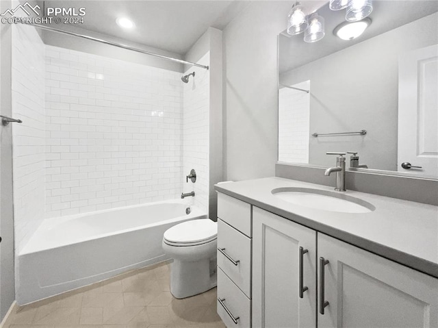 full bathroom featuring tiled shower / bath, toilet, and vanity