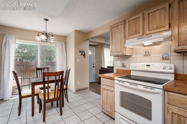 kitchen featuring white electric range oven, light tile patterned floors, decorative light fixtures, backsplash, and a chandelier