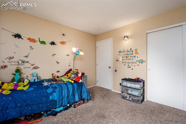 carpeted bedroom featuring a closet and a textured ceiling