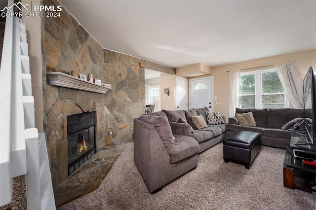 living room with a fireplace and carpet