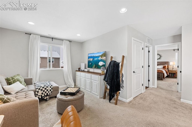 sitting room featuring light colored carpet