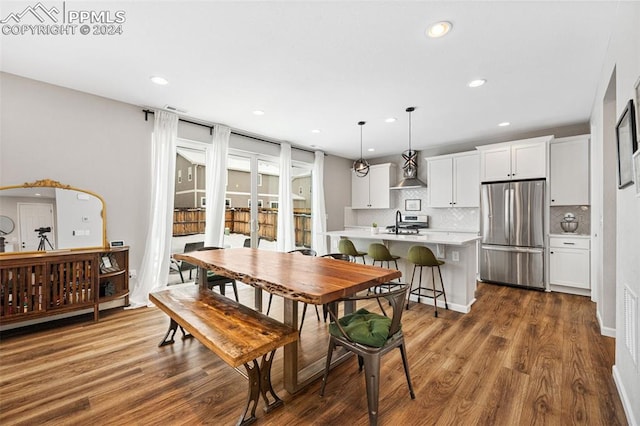 dining space with dark hardwood / wood-style floors and sink