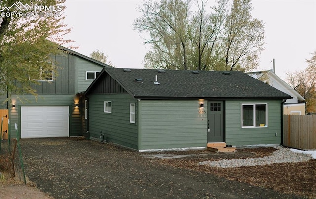 rear view of property with a garage