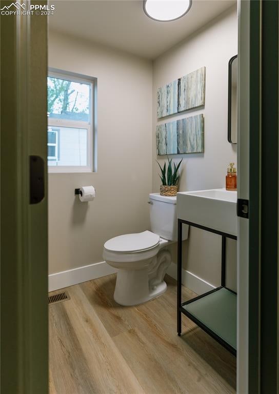 bathroom featuring toilet and hardwood / wood-style flooring