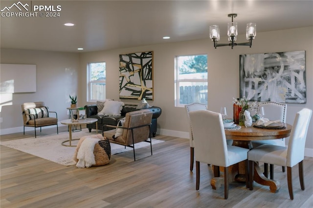 dining room with a chandelier and light wood-type flooring