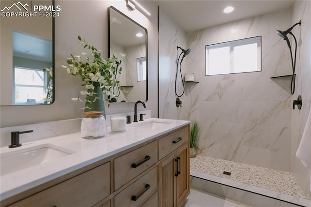 bathroom featuring a tile shower and vanity