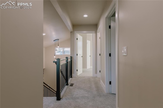 hall with light carpet and lofted ceiling