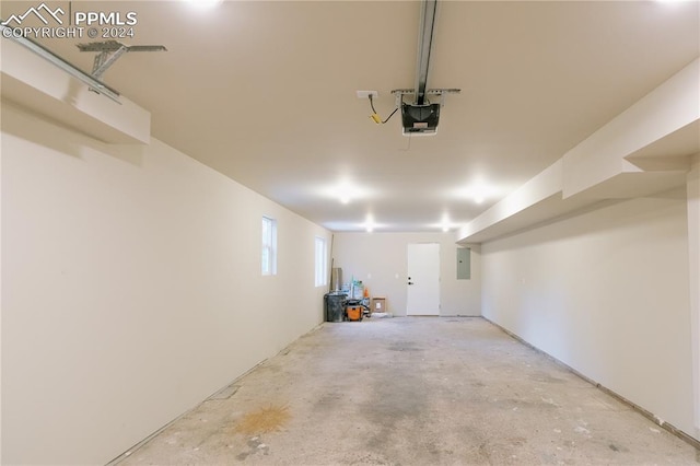 garage with electric panel and a garage door opener