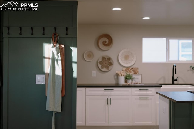 kitchen with white cabinetry and sink