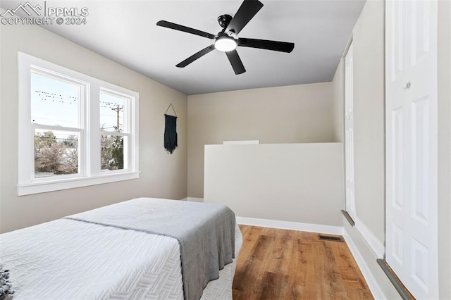 bedroom featuring a closet, hardwood / wood-style flooring, and ceiling fan