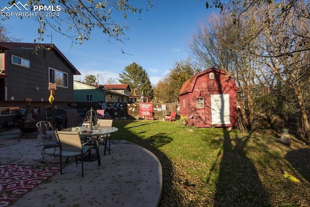 view of yard featuring a storage shed and a patio