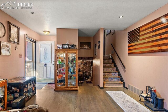 interior space featuring hardwood / wood-style flooring and a textured ceiling