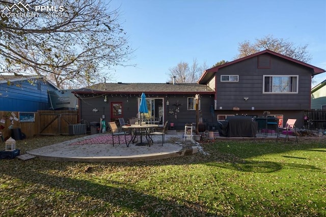 back of property featuring a patio, cooling unit, and a lawn