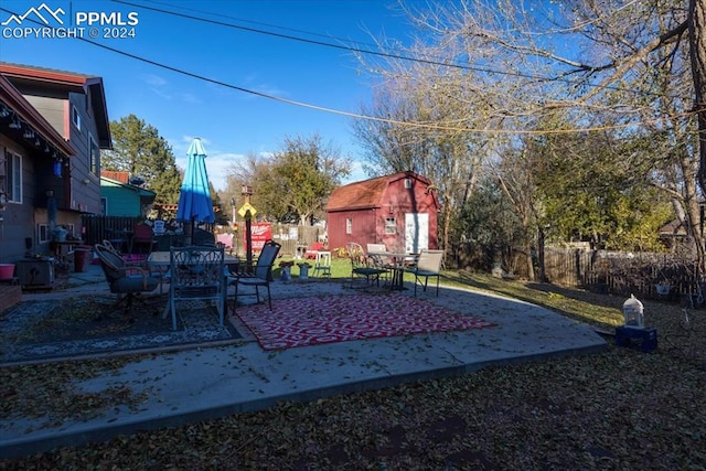 view of yard featuring a patio area and an outdoor structure